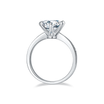 CARISSIE round moissanite solitaire ring, bottom profile view displaying the inner band finish and prong structure beneath the gemstone.