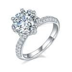 CARISSIE round moissanite engagement ring, angled view highlighting the high-profile crown setting and pavé band