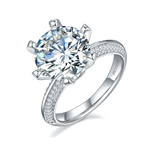 CARISSIE round moissanite engagement ring, angled view showing six-prong setting and pavé split shank band