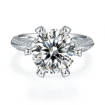 CARISSIE round moissanite solitaire ring, top-down view highlighting the brilliant-cut center stone and prongs