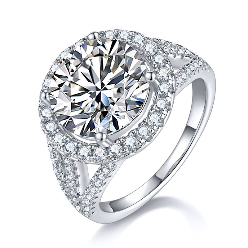 CARISSIE round moissanite halo engagement ring, angled top view highlighting the split shank band and pavé details