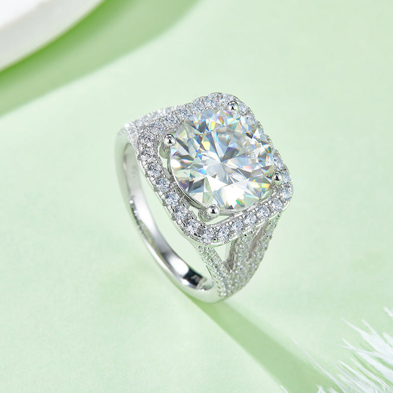 CARISSIE round moissanite statement ring, side angle on green background revealing the open bridge design