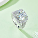 CARISSIE round moissanite statement ring, side angle on green background revealing the open bridge design