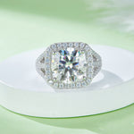 CARISSIE round moissanite halo ring, front view on a white pedestal showcasing the intense sparkle of the stones