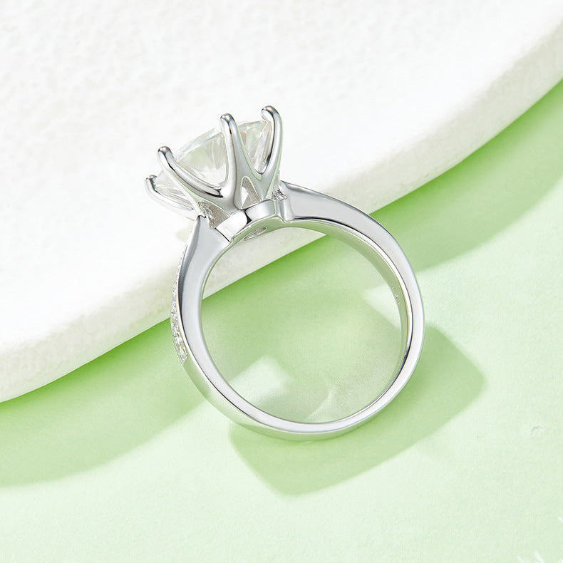 CARISSIE round moissanite engagement ring, side profile view displaying high-profile prongs and smooth polished inner band