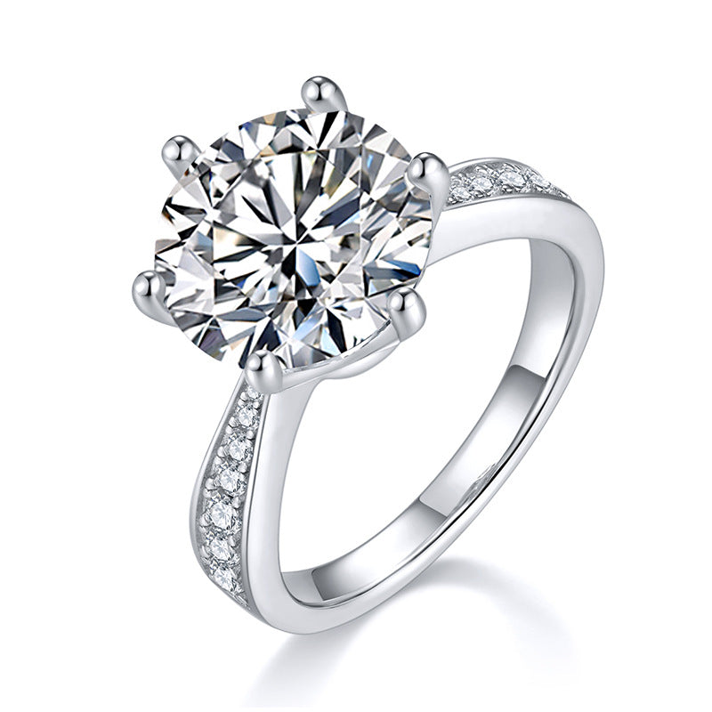 CARISSIE round moissanite engagement ring, angled view showing brilliant center stone and pavé split shank band