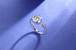 CARISSIE round moissanite bezel ring, standing upright on blue surface revealing curved shank and stone setting