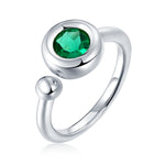 CARISSIE round moissanite bezel ring, high-angle view of green gemstone showcasing faceted cut and bezel rim