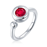 CARISSIE round moissanite bezel ring, isolated studio shot of red stone emphasizing spherical bead detail