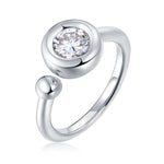 CARISSIE round moissanite bezel ring, detailed angle of clear center stone showing brilliance and metal finish