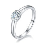 CARISSIE round moissanite bezel ring, angled view highlighting the smooth silver band and brilliant center stone