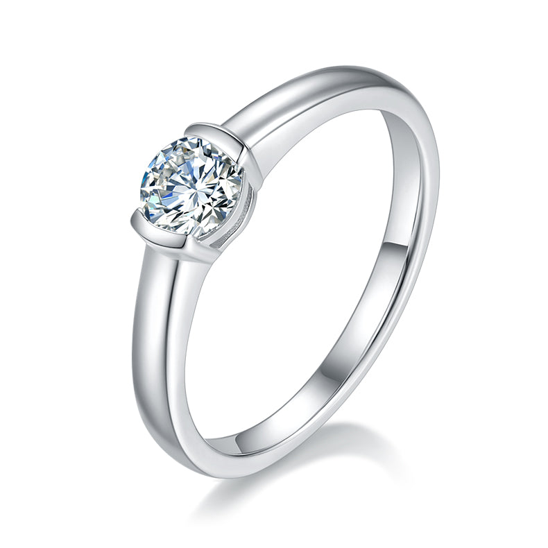 CARISSIE round moissanite bezel ring, angled view highlighting the smooth silver band and brilliant center stone