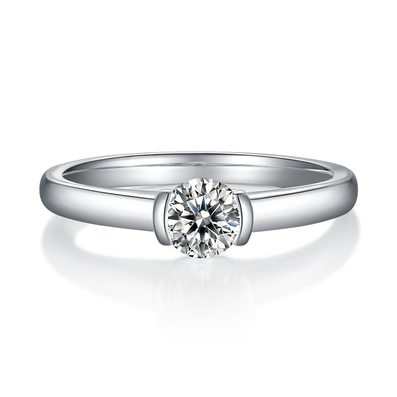 CARISSIE round moissanite solitaire ring, direct front view showing the symmetrical bezel setting and polished metal finish