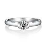 CARISSIE round moissanite solitaire ring, direct front view showing the symmetrical bezel setting and polished metal finish