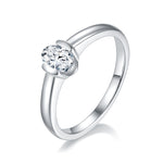 CARISSIE oval moissanite bezel ring, angled view showing the polished silver-tone band and secure metal rim