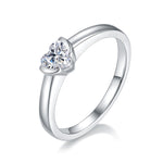 CARISSIE heart moissanite bezel ring, angled view highlighting the brilliant-cut stone and sleek silver-tone band.