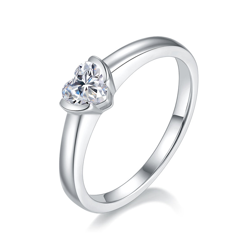CARISSIE heart moissanite bezel ring, angled view highlighting the brilliant-cut stone and sleek silver-tone band.