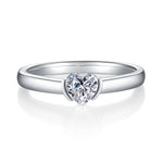 CARISSIE heart moissanite bezel ring, front view showing the smooth metal rim encasing the sparkling center gem.