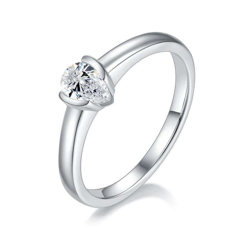 CARISSIE pear moissanite bezel engagement ring, angled view highlighting the sleek silver-tone band and protective rim