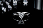 CARISSIE trillion engagement ring, straight-on view displaying the brilliant sparkle of the center stone against a dark backdrop