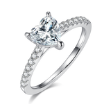 CARISSIE heart solitaire engagement ring, angled side view showing split shank band with pavé accents and three-prong setting