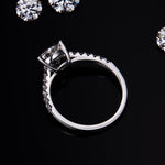 CARISSIE trillion solitaire engagement ring, close-up side angle detailing the high-polish metal finish and secure three-prong head