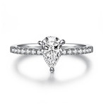 CARISSIE pear moissanite pavé ring, front view showcasing the symmetrical half-pavé band on a reflective surface
