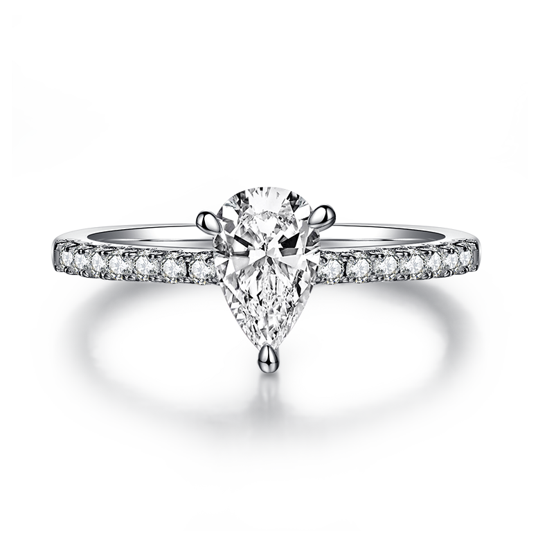 CARISSIE pear moissanite pavé ring, front view showcasing the symmetrical half-pavé band on a reflective surface