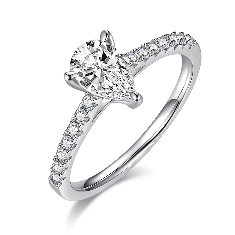 CARISSIE pear moissanite pavé ring, angled view highlighting the brilliant center stone and V-shaped prong detail