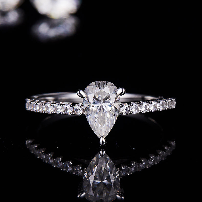 CARISSIE pear moissanite pavé ring, direct front shot displaying the sparkle of the 5x8mm stone and accent gems