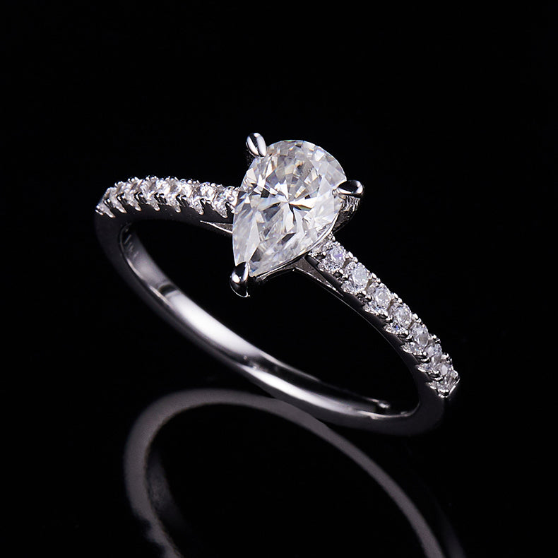 CARISSIE pear moissanite pavé ring, side profile against black background emphasizing the delicate silver-tone metal