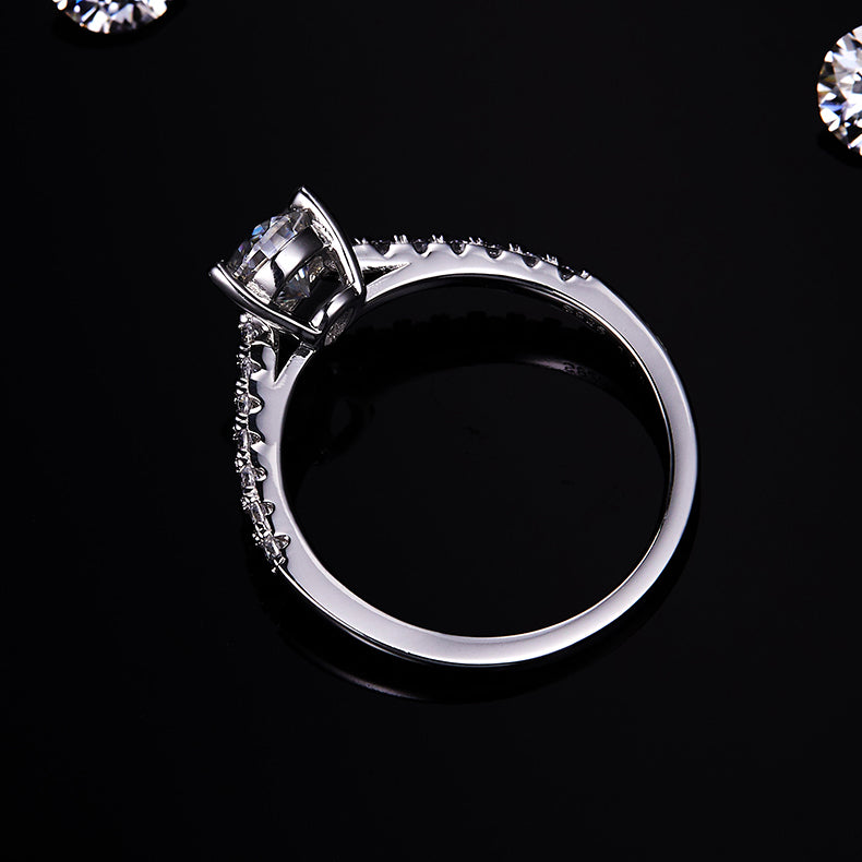 CARISSIE pear moissanite pavé ring, top-down angle showing the elegant curve of the band and secure setting