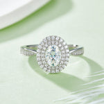 CARISSIE oval moissanite halo engagement ring, top-down view emphasizing the symmetry of the double halo and prong setting