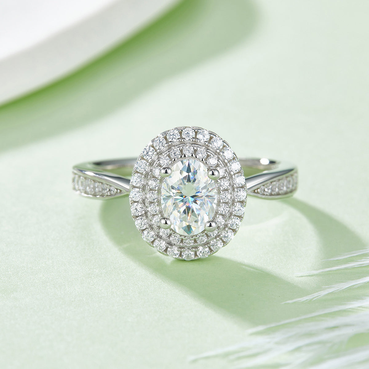 CARISSIE oval moissanite halo engagement ring, top-down view emphasizing the symmetry of the double halo and prong setting