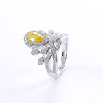CARISSIE pear moissanite halo ring, product photography of the yellow stone edition featuring delicate leaf accents