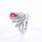 CARISSIE pear moissanite halo ring, high-contrast image of the pink stone model focusing on the brilliant cut facets