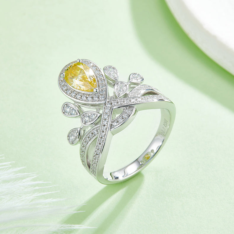 CARISSIE pear moissanite halo ring, close-up of the yellow gemstone variant showcasing the sparkling pave details