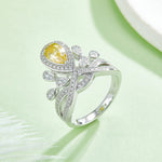 CARISSIE pear moissanite halo ring, close-up of the yellow gemstone variant showcasing the sparkling pave details