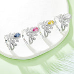 CARISSIE pear moissanite halo ring set, lineup of four color variations displayed on a textured white surface