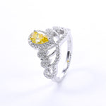 CARISSIE pear moissanite halo engagement ring, angled perspective featuring a vibrant yellow center stone surrounded by white diamond accents