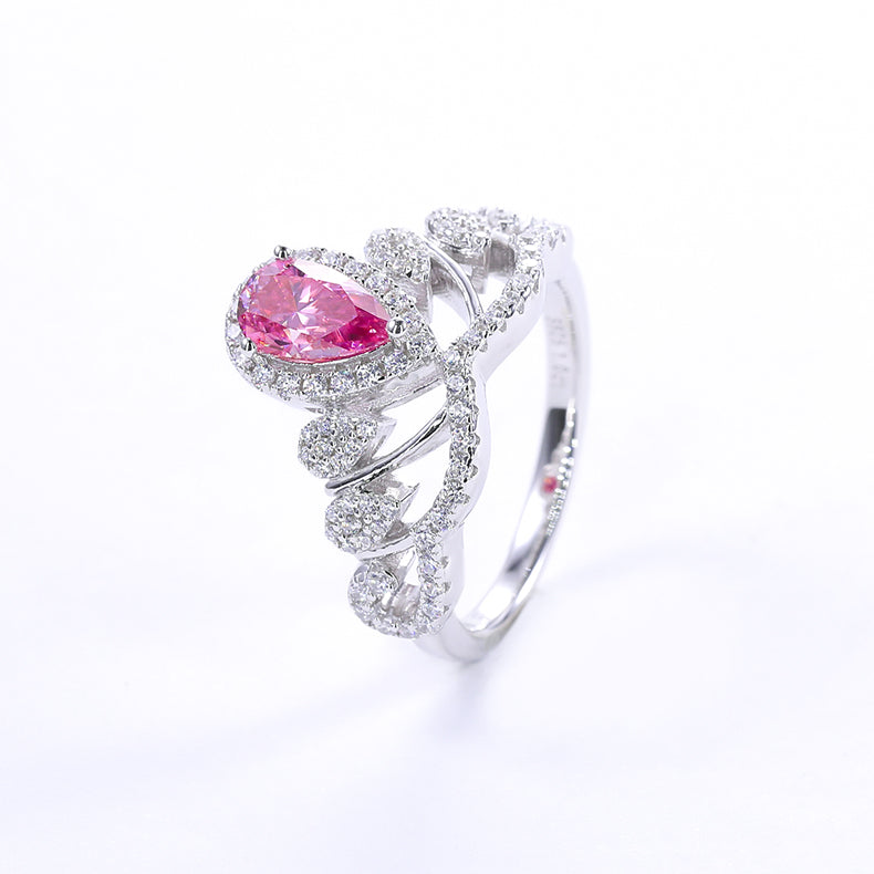 CARISSIE pear moissanite halo engagement ring, side angle presenting a vivid pink center stone encircled by a sparkling white halo
