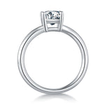 CARISSIE emerald cut moissanite solitaire ring, side profile revealing the smooth polished metal band and open gallery under the stone