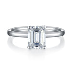 CARISSIE emerald cut moissanite solitaire ring, front view showcasing the symmetrical clarity of the center gem and four prong setting
