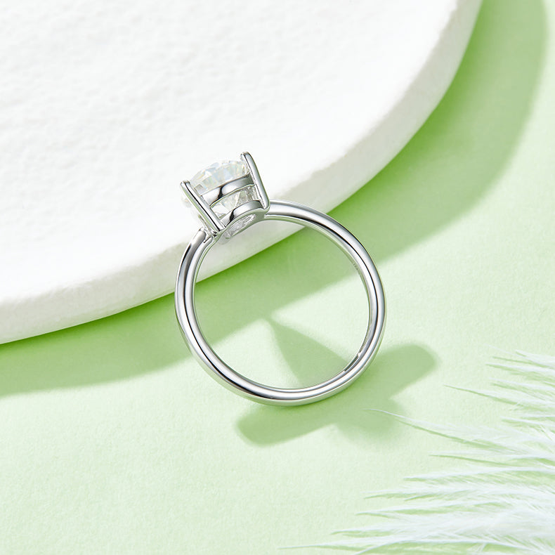 CARISSIE pear moissanite solitaire ring, close-up side angle emphasizing the smooth curve of the band and stone height