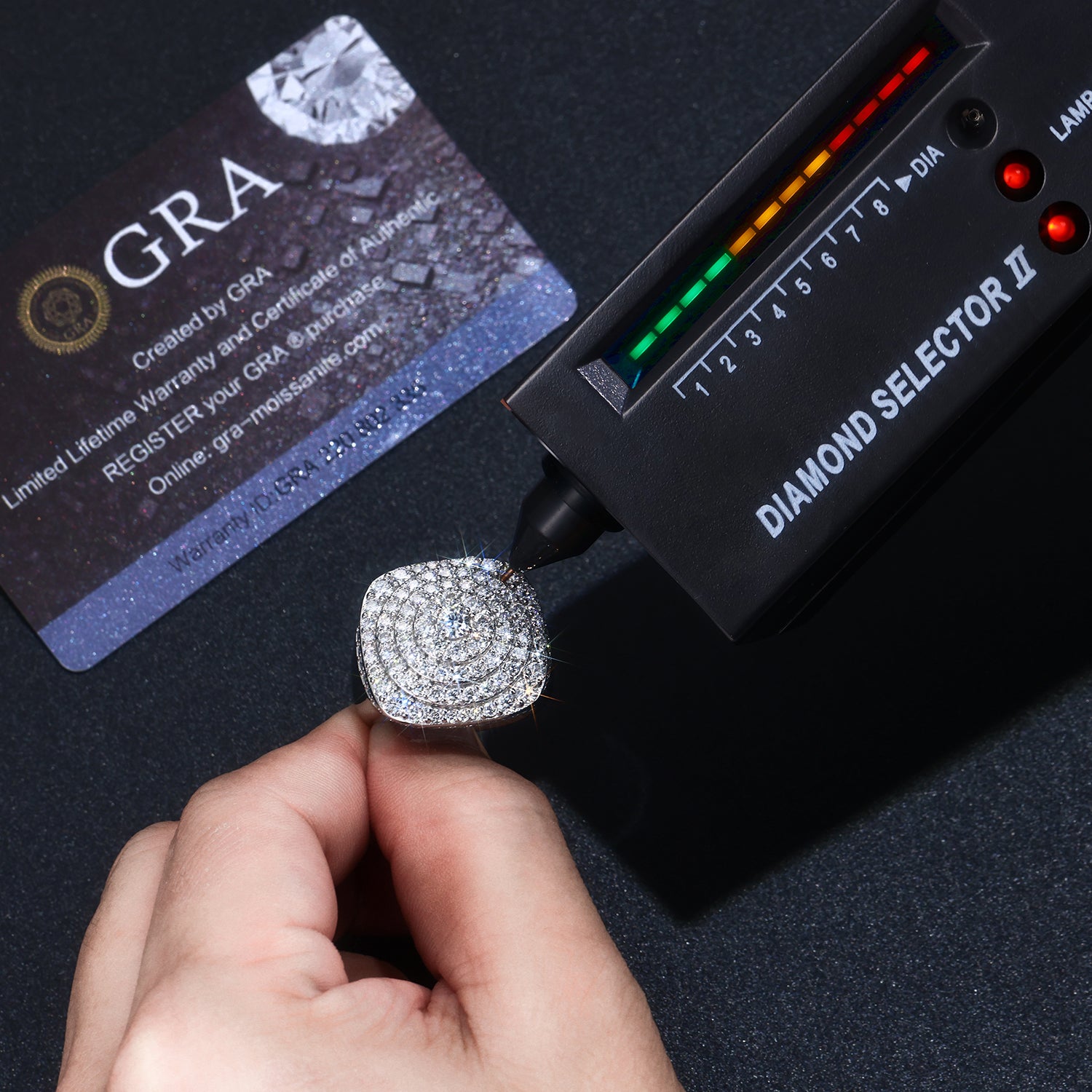 CARISSIE cushion moissanite statement ring tested with diamond selector tool showing thermal conductivity next to GRA certificate card
