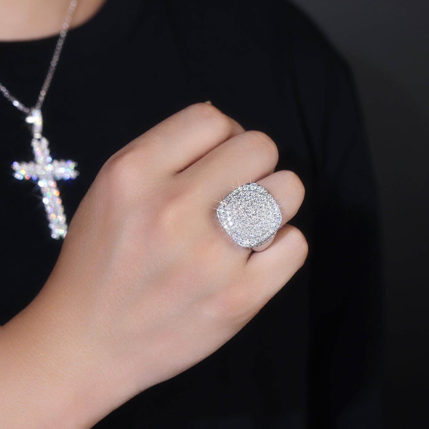 CARISSIE cushion moissanite statement ring on model hand, displaying tiered pavé stones and silver-tone band against black shirt