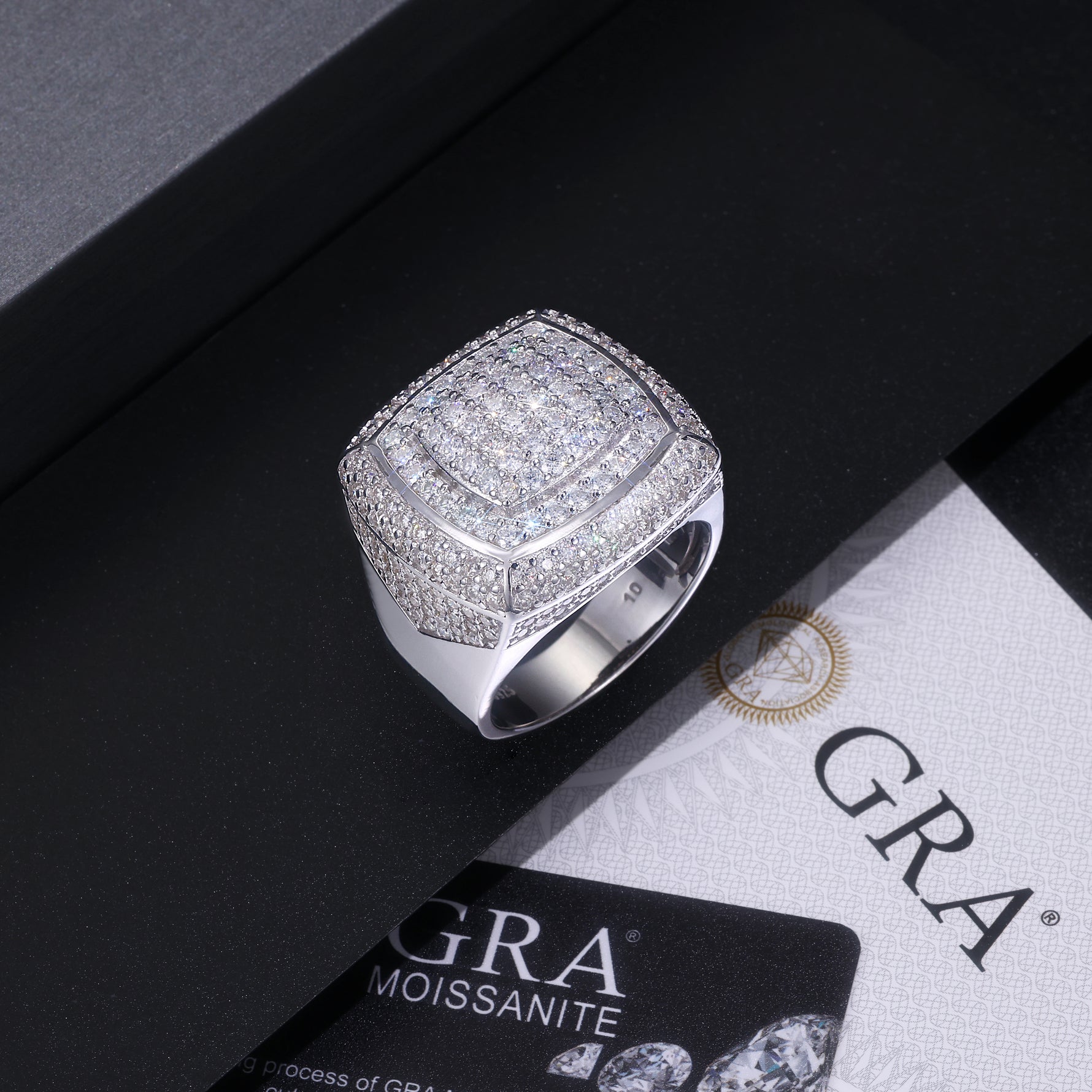 CARISSIE round moissanite statement ring resting on a black box with GRA certificate, emphasizing premium packaging and quality