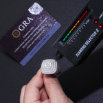 CARISSIE cushion moissanite statement ring, being tested by a diamond selector tool to verify thermal conductivity