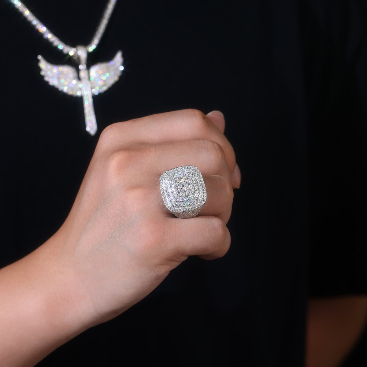 CARISSIE cushion moissanite statement ring, worn on hand displaying scale against skin with matching wing pendant