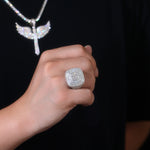 CARISSIE cushion moissanite statement ring, worn on hand displaying scale against skin with matching wing pendant